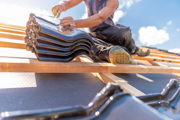manufacture of the roof of a family house from ceramic tiles. copy space
